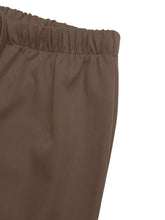 Brown wide leg drawstring pants with elastic waist and subtle ribbed texture for comfortable wear