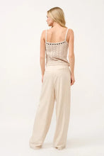 Beige crochet tank top with delicate lace and thin straps paired with wide leg linen blended pants