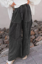 Dark gray wide leg denim pants with unique mineral wash tiered design and drawstring waist for casual wear