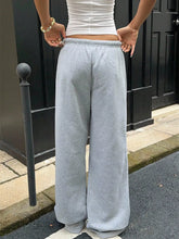 Light gray wide leg drawstring sweatpants with elastic waistband in loose fit and soft fabric for comfortable wear