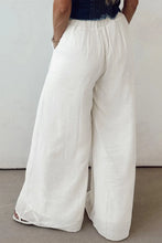 Flowy wide leg white pants with elastic drawstring waistband and relaxed flowing fabric for comfortable wear