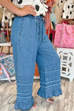 Blue chambray pants with wide leg fit ruffled hem and drawstring waist for comfortable casual wear