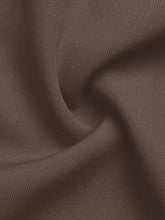 A close-up of soft ribbed brown fabric showing texture and folds on wide leg drawstring pants
