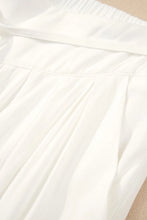 White pleated skirt with soft flowing fabric and elastic waistband paired with flowy wide leg pants design