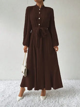 Dark brown long sleeve maxi dress with button tie waist and white heels