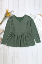 Dark green long sleeve peplum top with textured ruffles and V-neck