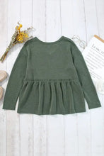 Dark green long sleeve peplum top with textured ruffles and V-neck