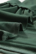 Dark green long sleeve peplum top with textured ruffles