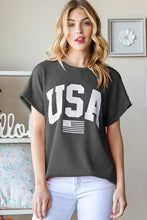 Dark grey graphic short sleeve top with bold USA graphic and American flag