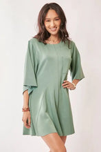 Sage green Davi & Dani romper with draped bell sleeves and ties back