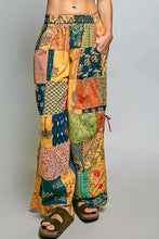 Pol printed patchwork wide leg pants in vibrant orange teal green and yellow with adjustable side drawstring