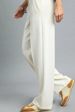 Cream-colored umgee high waisted wide-leg pants with smooth flowing fabric and subtle front pleats