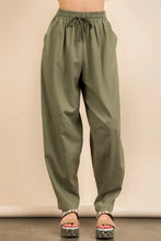 Olive green solid barrel comfy woven pants with a relaxed tapered fit and subtle side seam details