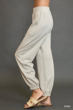 Beige umgee drawstring jogger pants with elastic waist side pockets cuffed hems and front seam detail