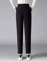 Black high-waisted loose fit trousers with elastic waist loose fit and smooth tailored fabric for comfortable wear