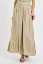 Beige risen shirring detail wide leg pants with high waist pleated front panels and ruffled hems