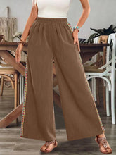 Bohemian wide leg brown trousers with pleated waistband and wide leg embroidered side panels with care instructions
