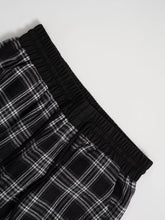 Black and white plaid pants with elastic waistband featuring a relaxed fit perfect for casual wear