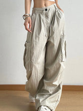 Beige drawstring wide leg cargo pants with multiple pockets designed for casual and functional wear