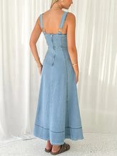 Light blue denim dress with thin straps and back zipper showcasing the back of the a-line denim dress design