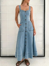 Light blue a-line denim dress with square neckline, button-front closure, and two front pockets in denim material