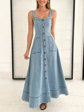 A light blue denim dress with a fitted bodice button-front detailing and two front patch pockets a-line denim dress