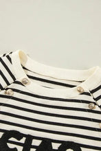 White and black striped long-sleeve baby romper with decorative silver buttons
