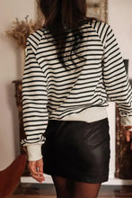 Black and white striped long sleeve sweatshirt with decorative buttons and mini skirt