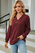 Women’s long sleeve maroon V-neck sweater with decorative buttons