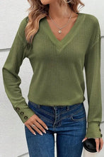 Olive green waffle knit V-neck long sleeve top with decorative button cuffs