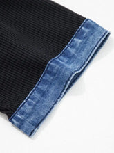 Black ribbed knit top with denim trim button detail and denim cuff for a stylish casual look