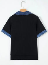 Black ribbed knit short-sleeved top with denim trim collar and sleeve cuffs featuring trim button detail