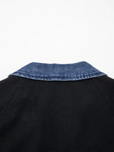 Black ribbed knit sweater with blue denim trim collar and trim button detail top for stylish layering