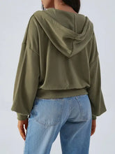 Devine Drawstring Zip long sleeve hoodie in olive green with jeans
