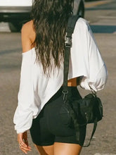 Woman in Devine One Shoulder Long Sleeve T-Shirt, biker shorts, crossbody bag