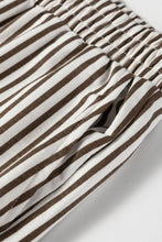 Brown and white striped elastic high waist pants with pockets featuring a loose fit and comfortable fabric
