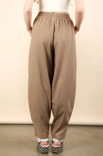 Beige solid barrel comfy high-waisted woven pants with elastic waistband and tapered legs perfect for casual wear