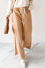 Tan satin wide leg pants with white polka dot print and a drawstring waist for comfortable wear
