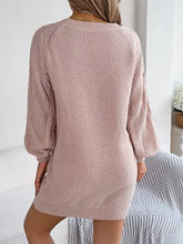 Diamond cable knit blush pink sweater dress with textured pattern and ribbed cuffs