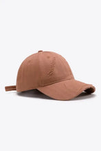 Distressed adjustable baseball cap with brown fabric and strap