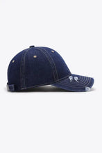 Distressed navy blue denim baseball cap with white stitching