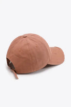 Distressed adjustable baseball cap with solid color and strap
