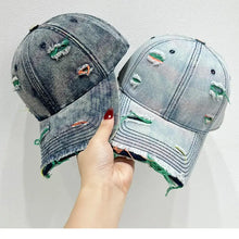 Two distressed adjustable baseball caps in dark and light wash denim
