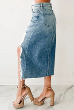 A mid-thigh length distressed asymmetrical denim skirt with frayed hem and classic back pockets visible from the back side