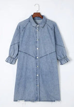 Light blue denim dress with distressed collared neck button-up front and ruffled three-quarter length flounce sleeves