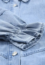 Light blue denim dress with distressed collared neck and flounce sleeves featuring silver buttons