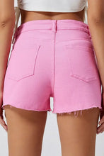 Pink distressed denim shorts with raw hem
