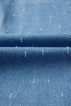 Denim fabric with subtle blue hue and white embroidered dashes on distressed detail tummy control raw hem jeans