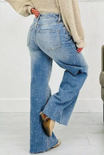 Light-wash denim tummy control raw hem jeans with a subtle crosshatch pattern and frayed hems