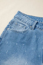 Light-wash denim tummy control raw hem jeans with subtle distressed pattern and stitched tear effects